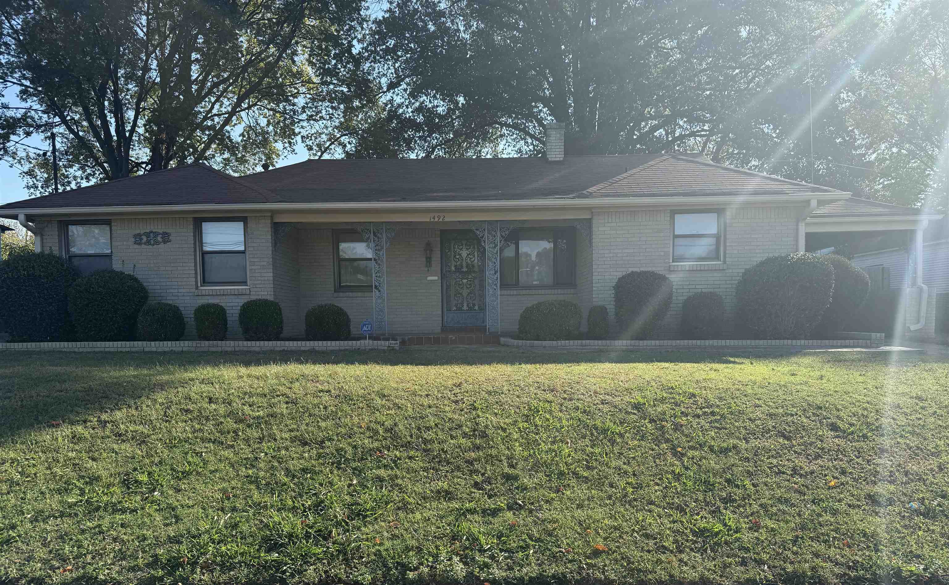 a front view of house with yard and trees