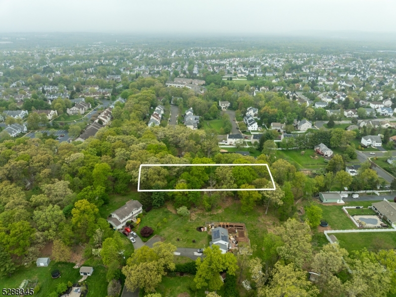 an aerial view of a houses with a yard