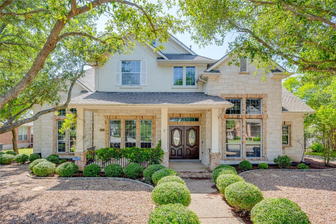 a front view of a house with garden