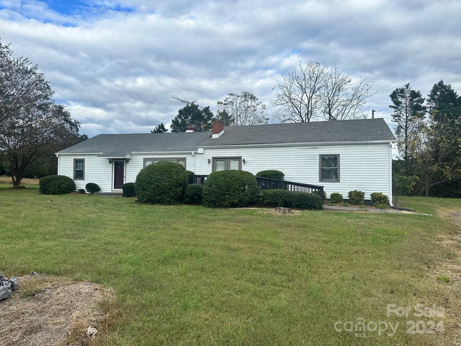 a front view of house with yard and trees