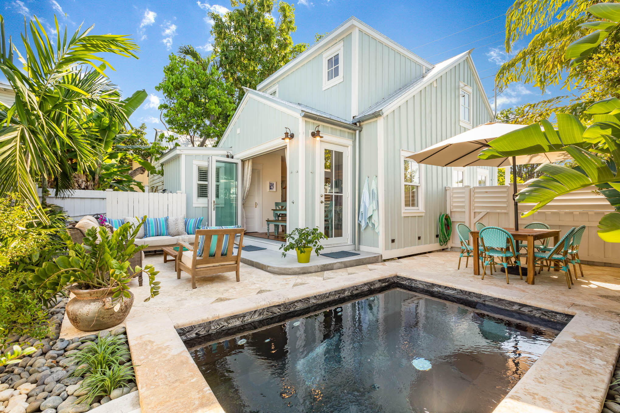 a swimming pool view with a outdoor seating