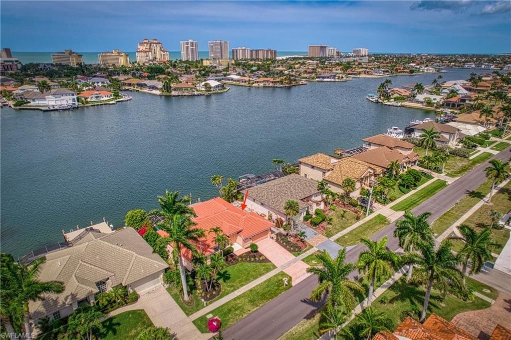 an aerial view of a houses with a lake view