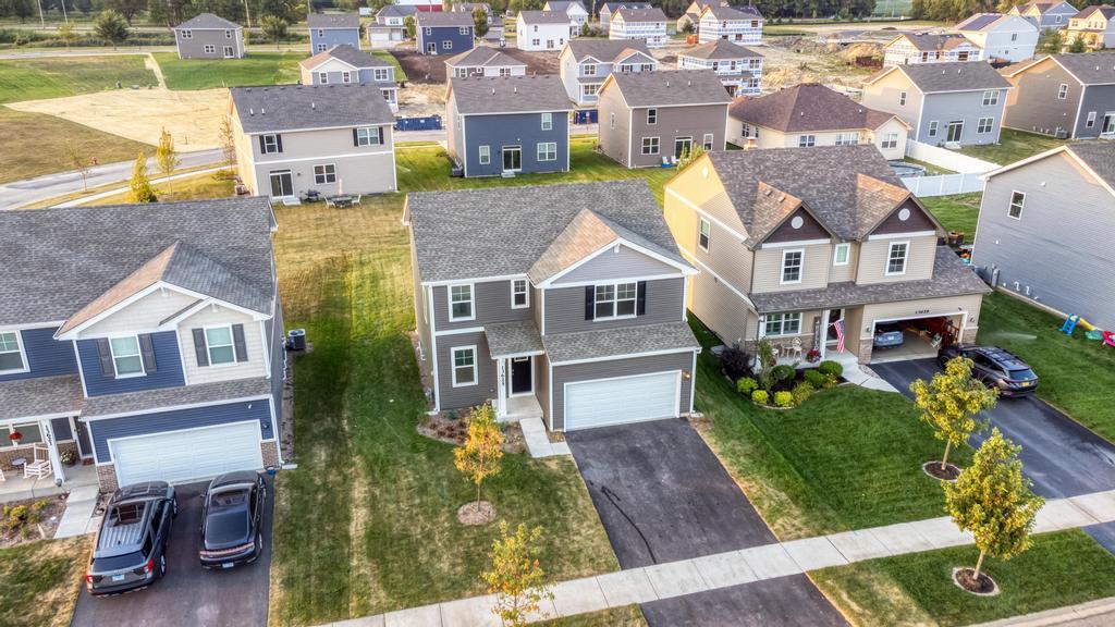 an aerial view of residential houses with outdoor space and parking