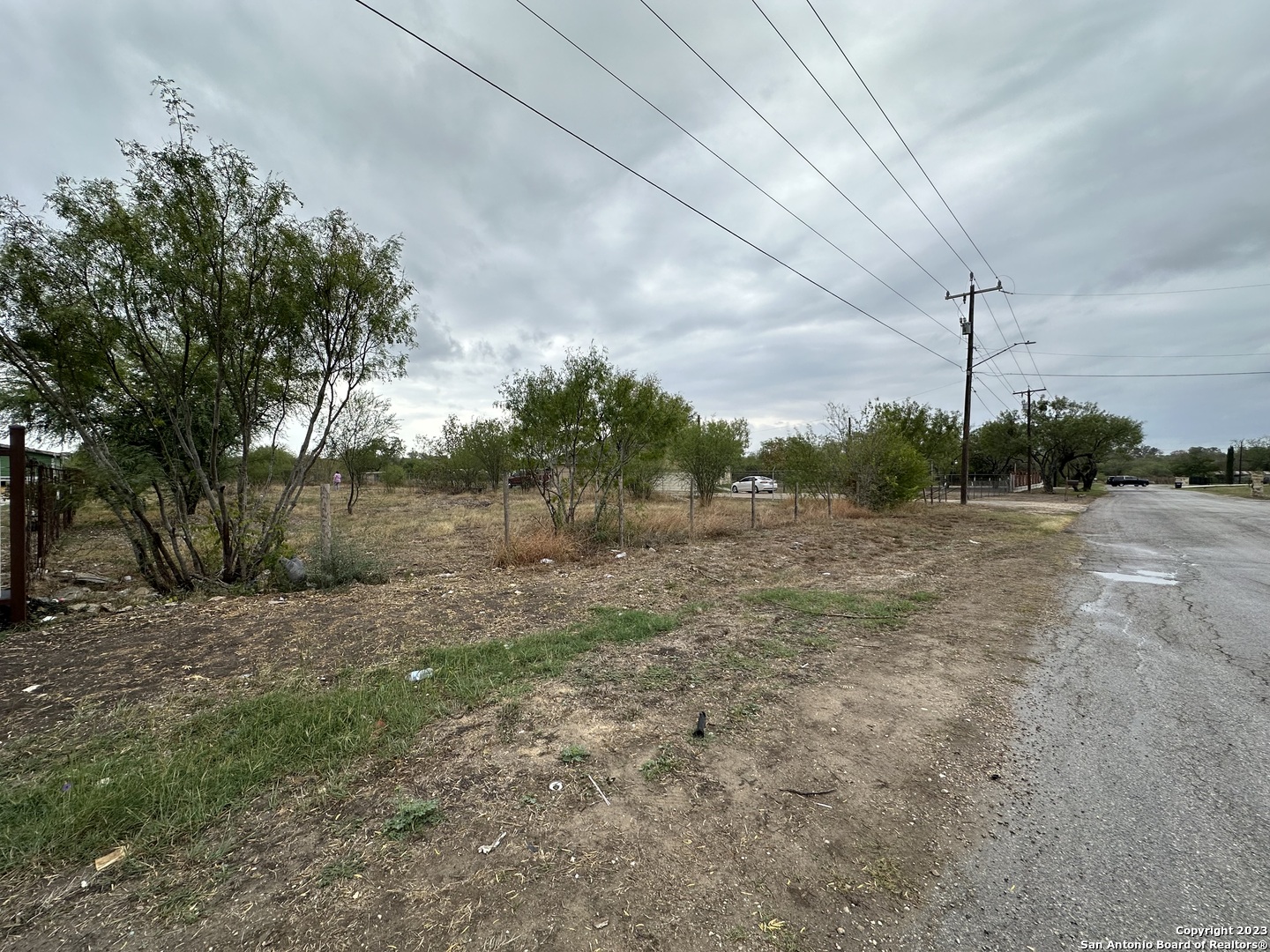 a view of a field with wooden fence