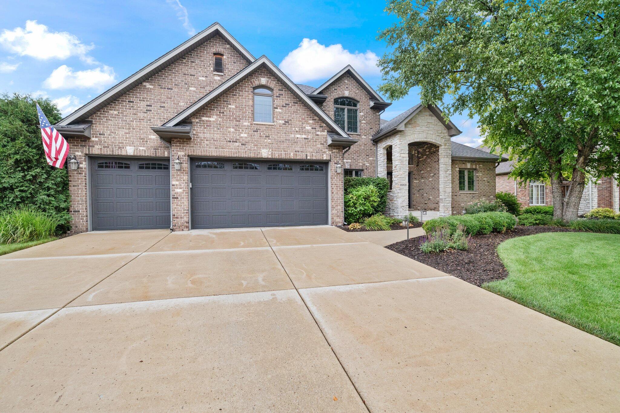 a front view of a house with a yard and garage