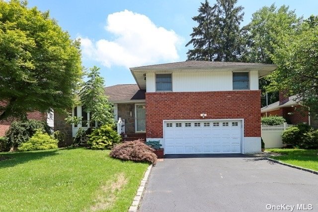 a front view of a house with a garden and plants