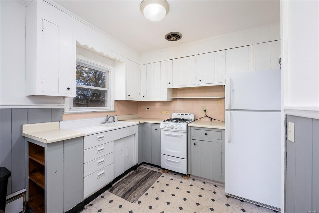 a kitchen with a sink a stove and cabinets