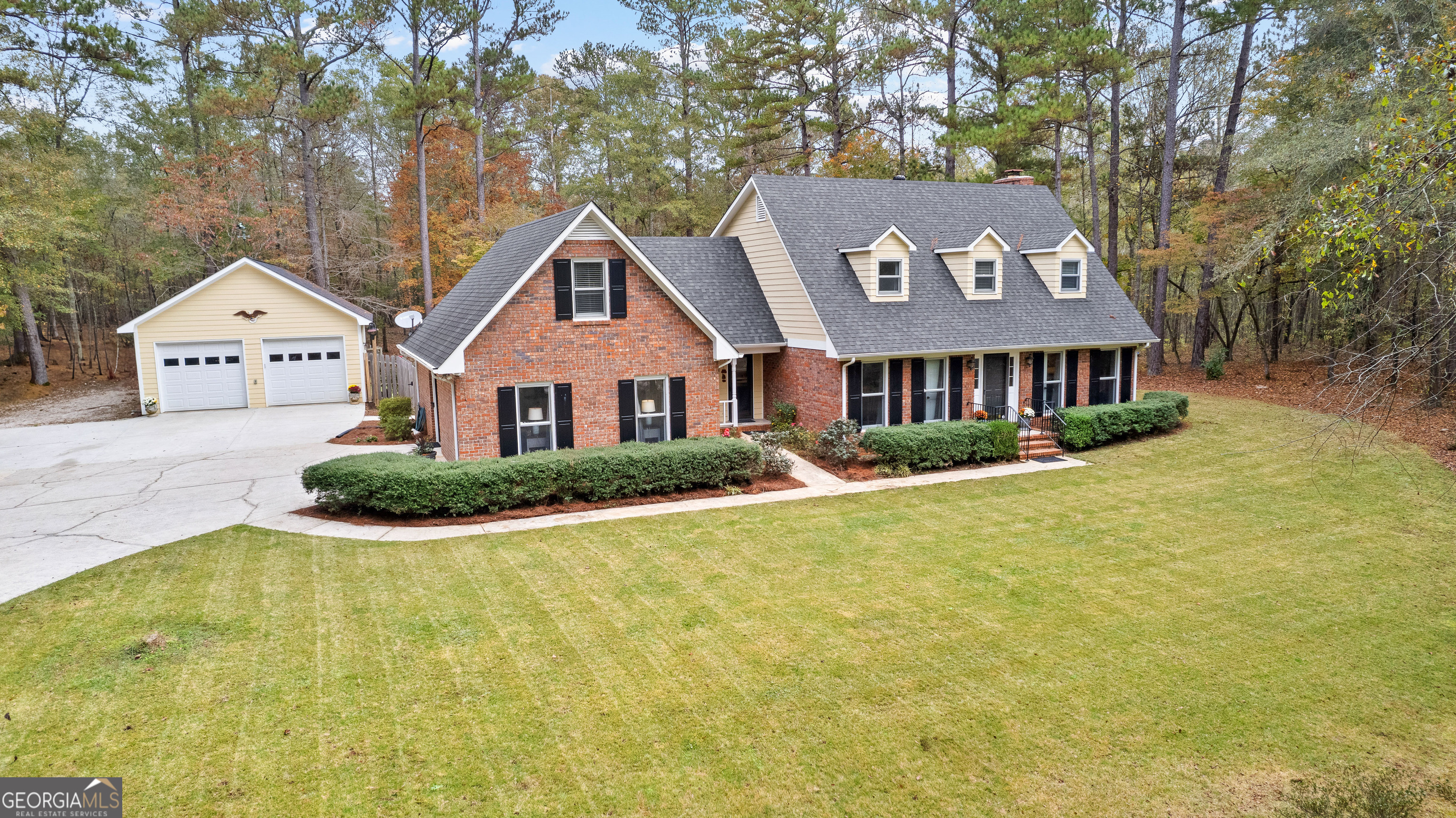 a front view of a house with yard and green space