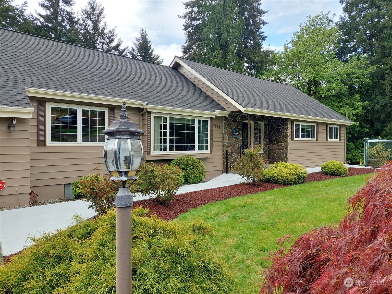 a front view of house with yard and green space