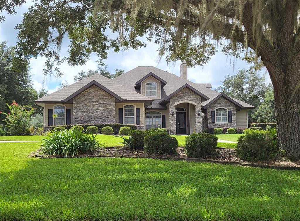 a front view of a house with garden