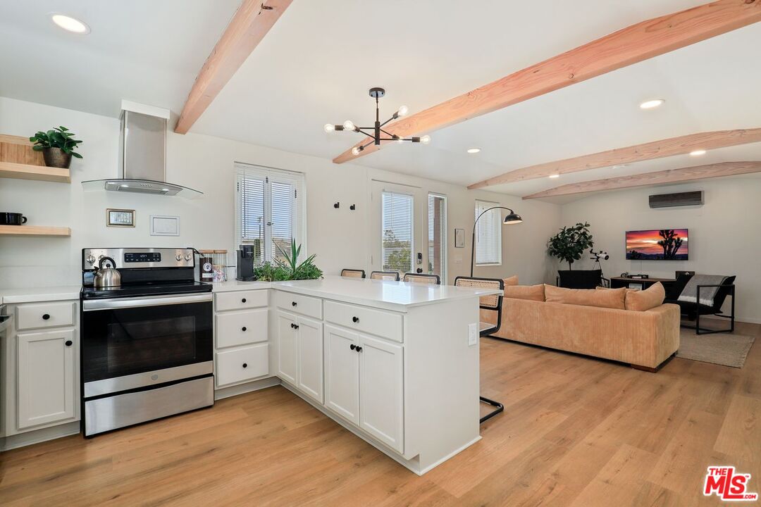 a kitchen with stainless steel appliances a stove top oven and cabinets