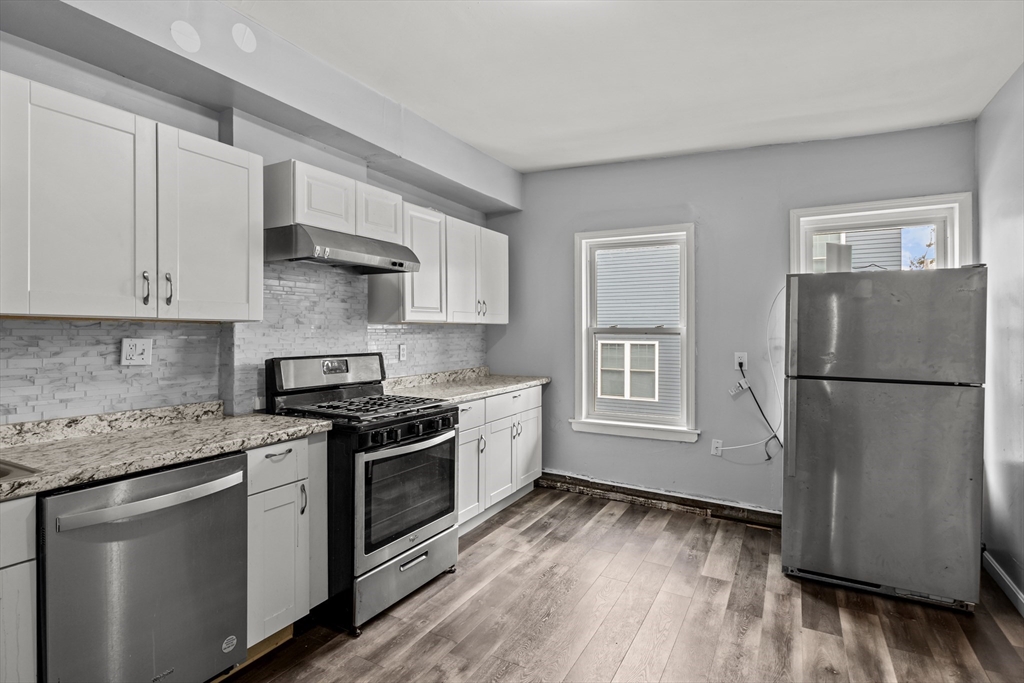 a kitchen with a stove a sink and a refrigerator