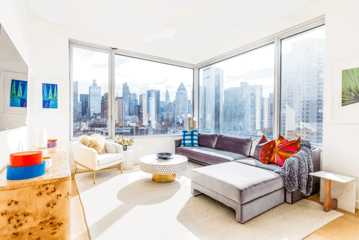 a living room with patio furniture and a large window