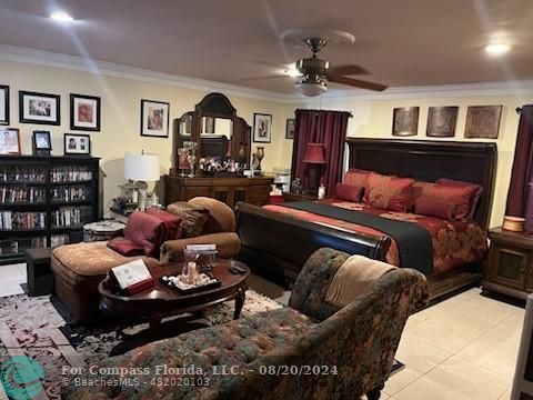 a living room with furniture or chandelier and a wooden floor