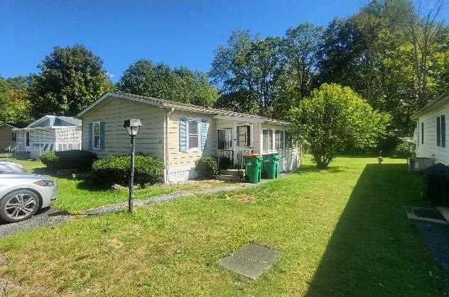 a view of a house with a backyard