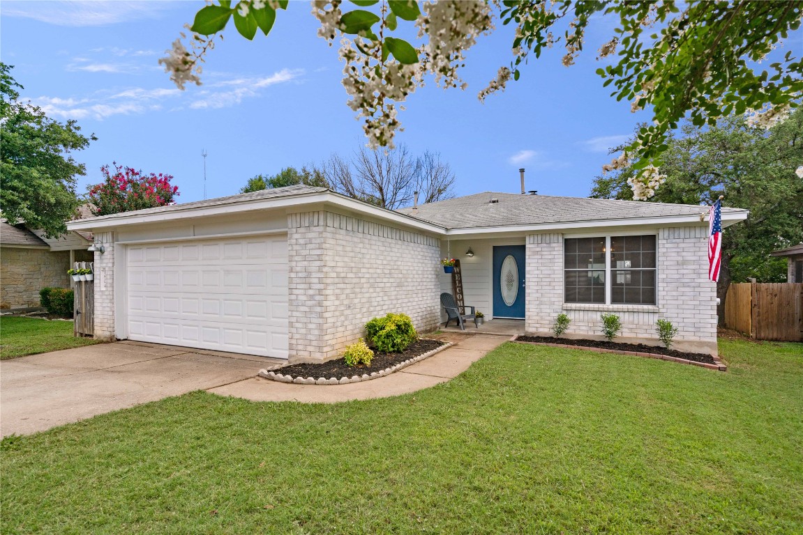 a view of a house with a yard and tree