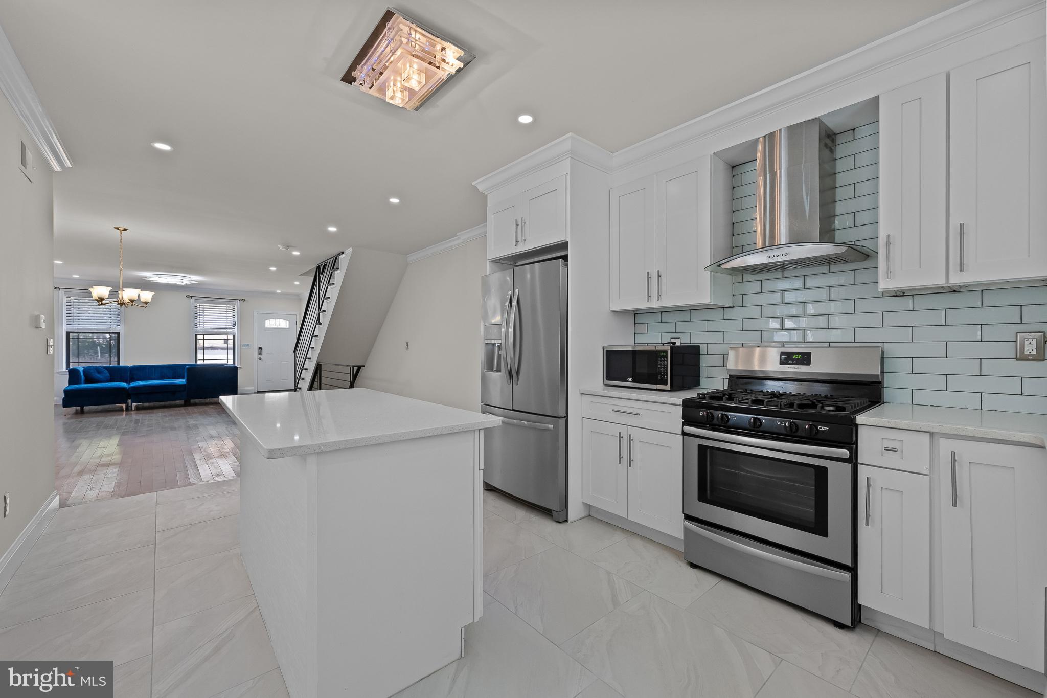 a kitchen with a stove and a refrigerator