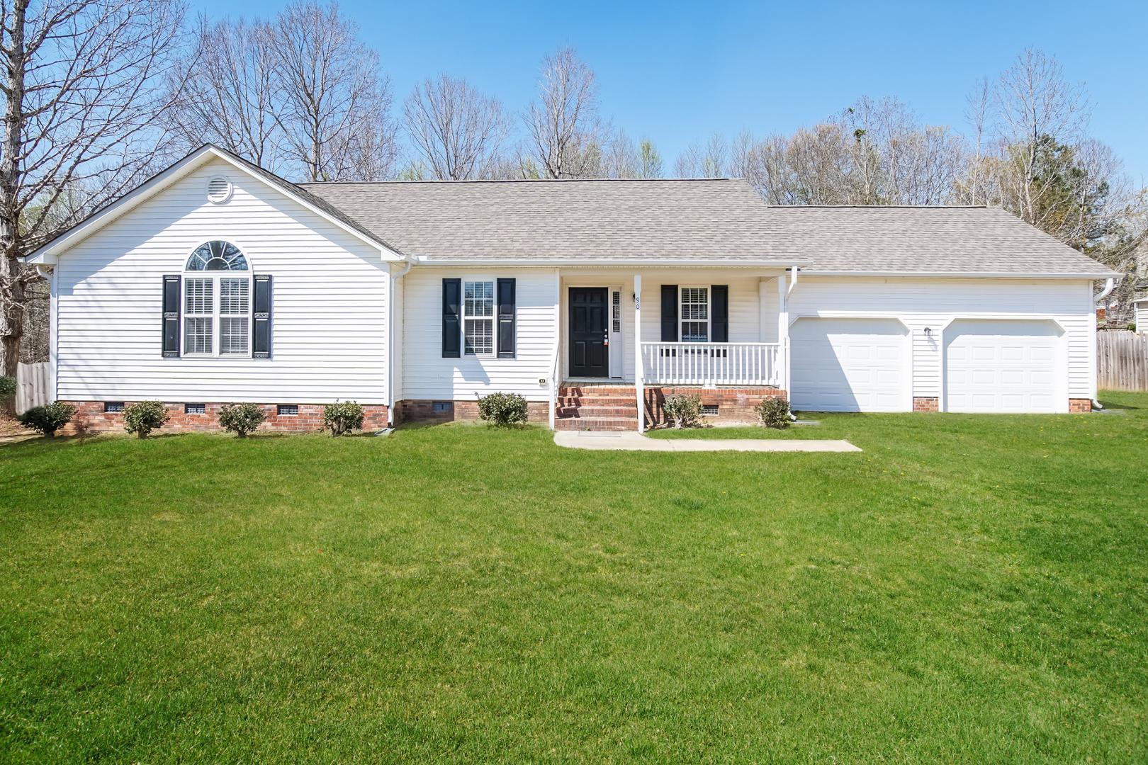 a front view of house with yard and green space