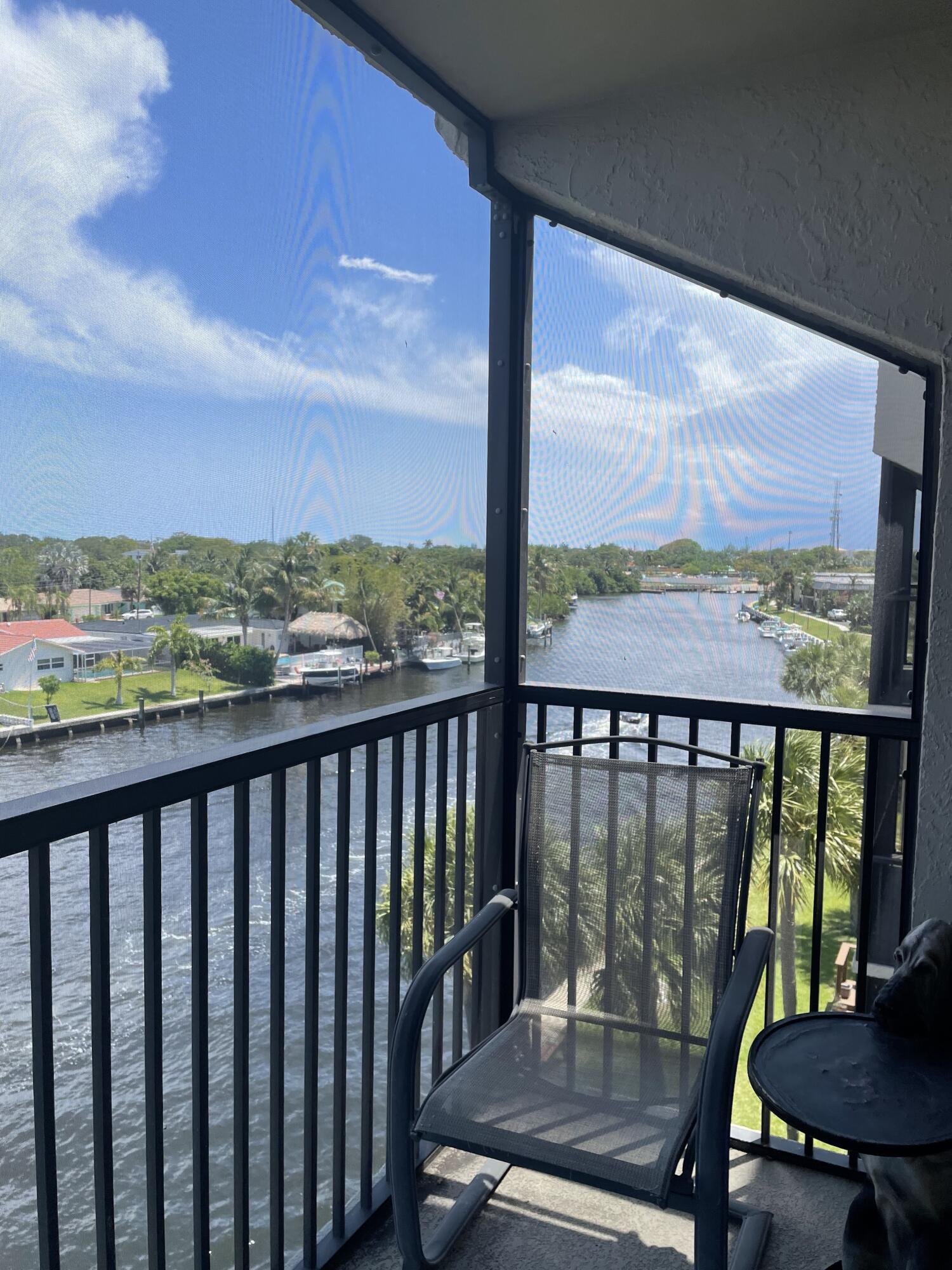 a view of a city from a balcony with furniture