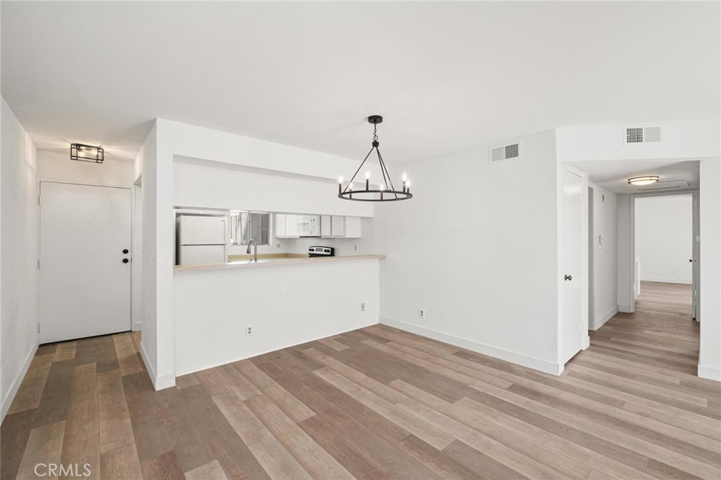 a view of a kitchen with wooden floor and a sink