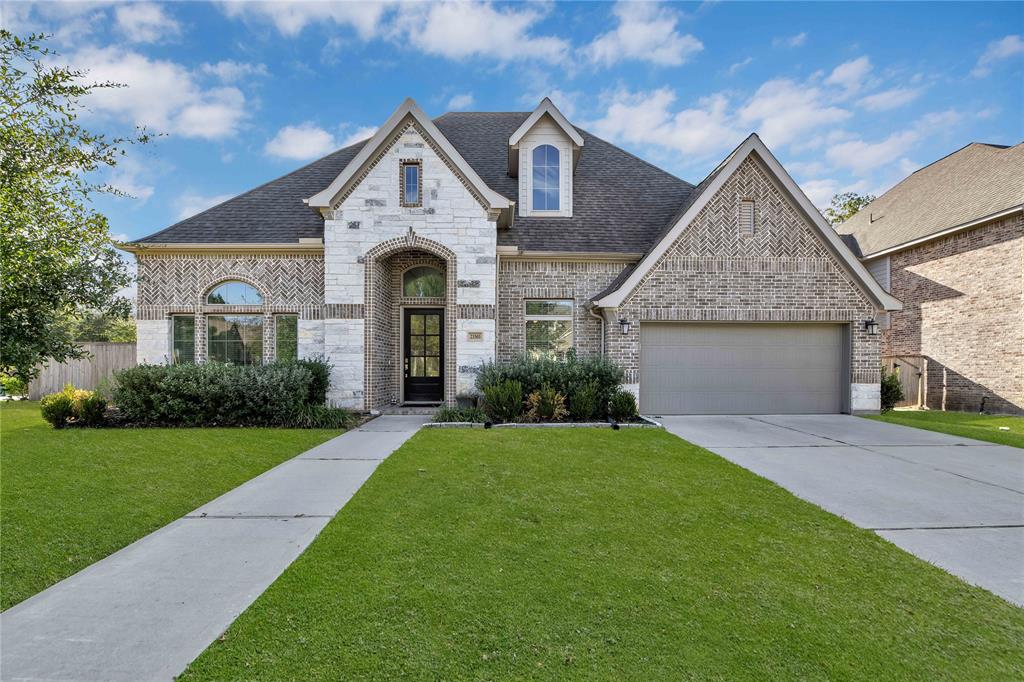 a front view of a house with a yard and garage