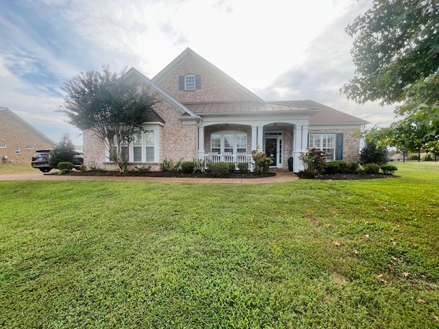 a front view of a house with a yard and trees