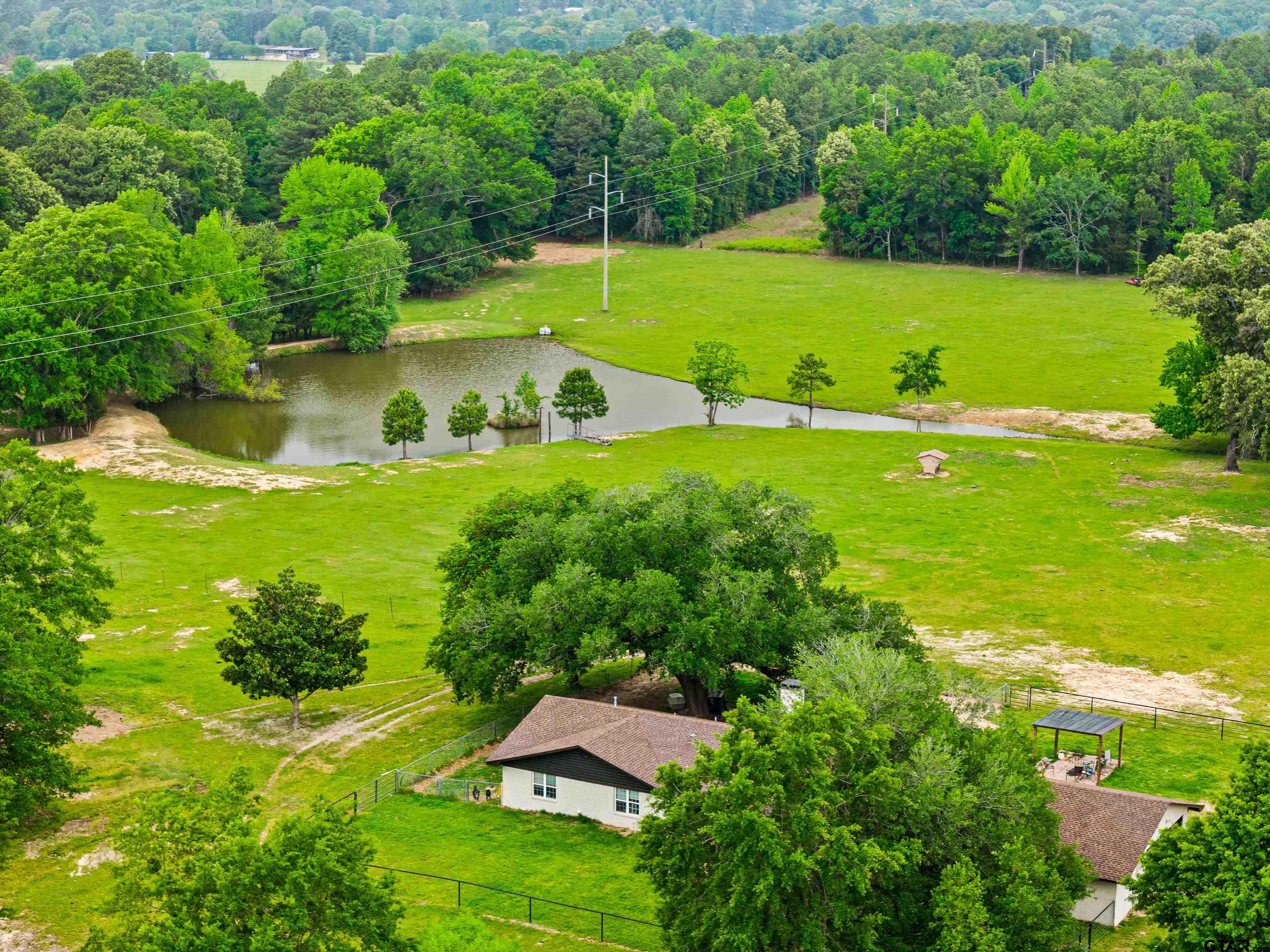 an aerial view of a house with a yard