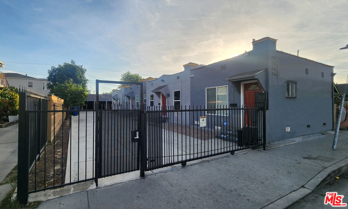 a view of a house with iron fence