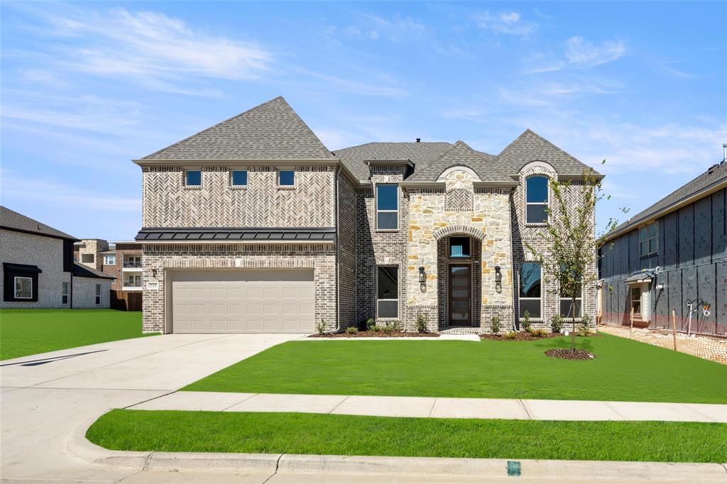 a front view of a house with a yard and garage