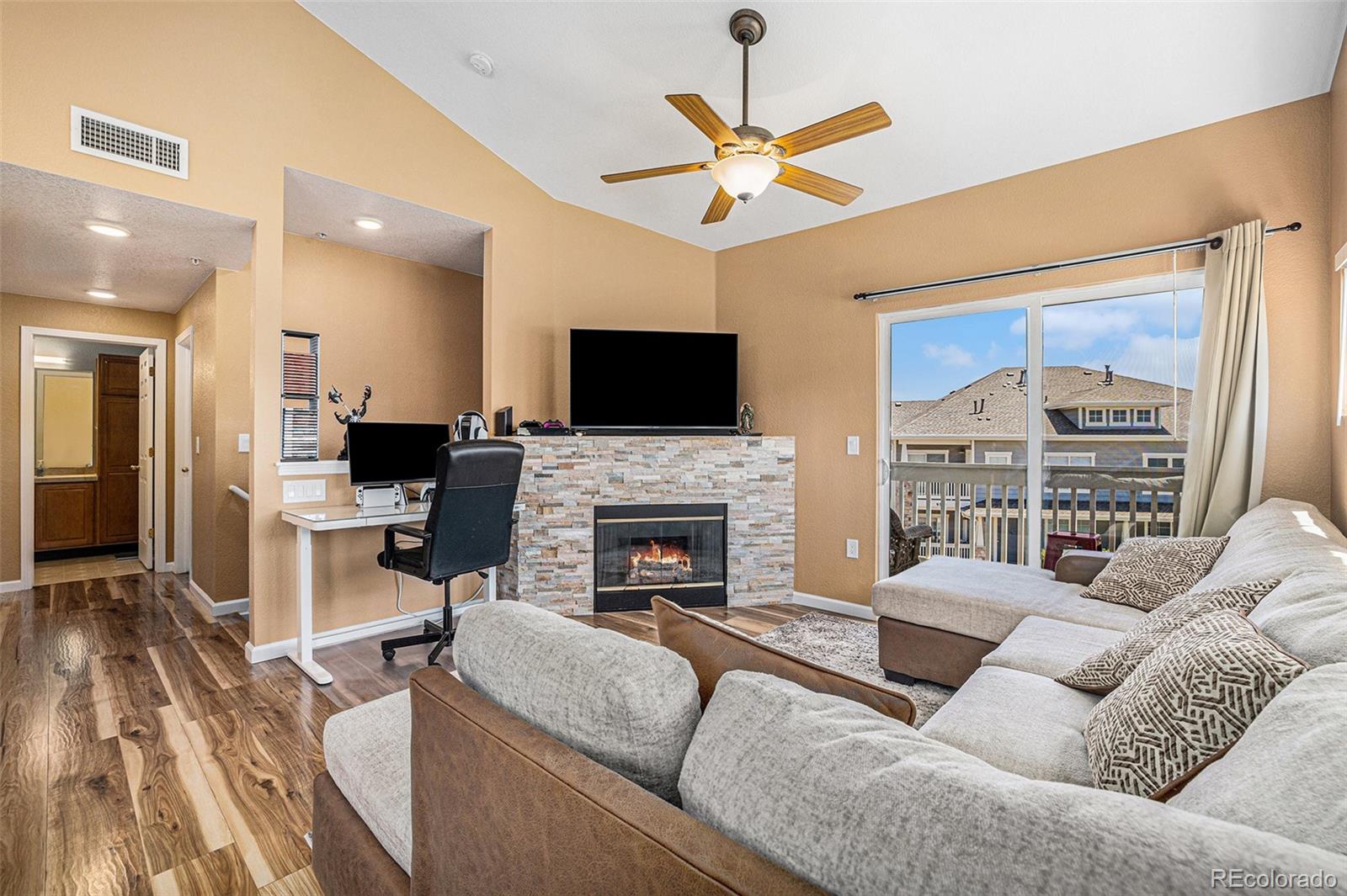 a living room with furniture a fireplace and a flat screen tv