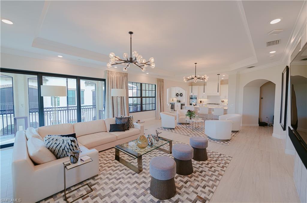 a living room with furniture and a chandelier