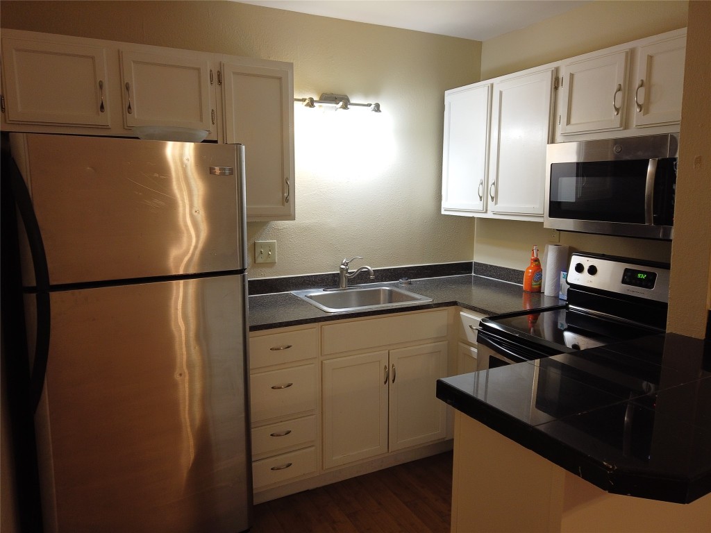 a kitchen with a refrigerator and a sink