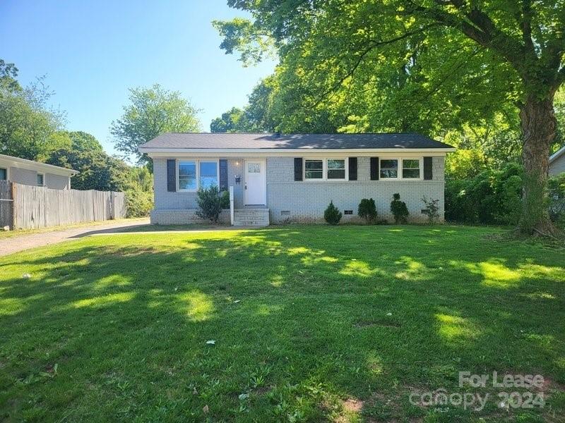 a front view of a house with yard and green space