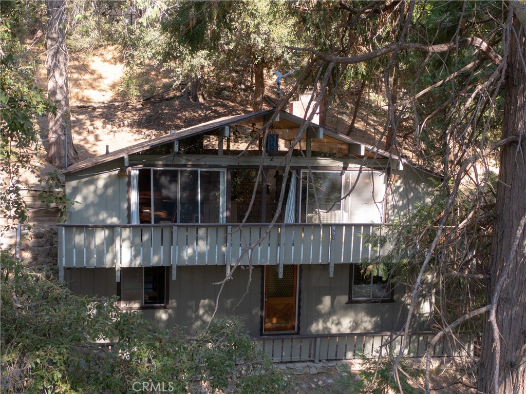 a view of house with a yard and wooden fence