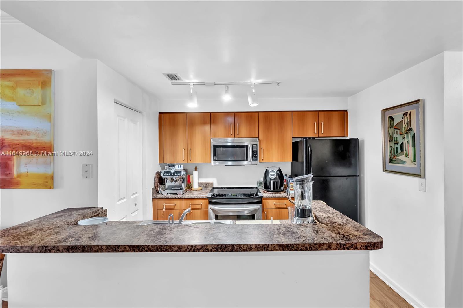 a kitchen with a refrigerator and a sink