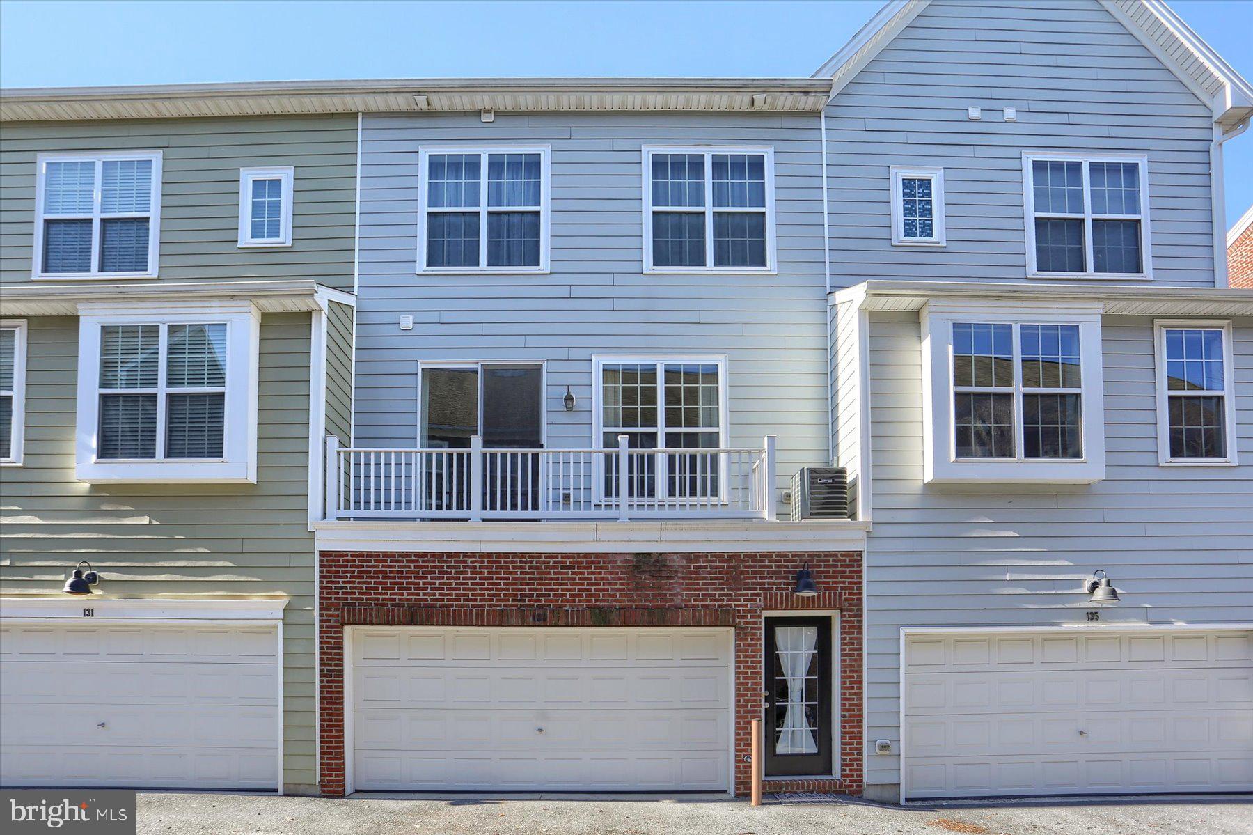 a front view of a house with large windows