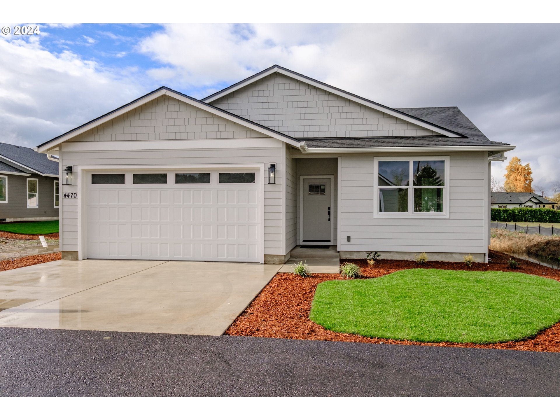 a view of a yard in front of a house with garage