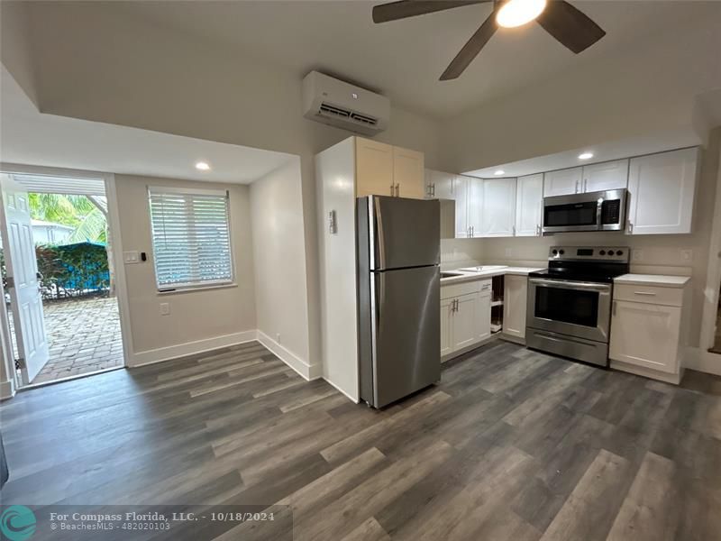 a kitchen with stainless steel appliances a refrigerator stove microwave and sink