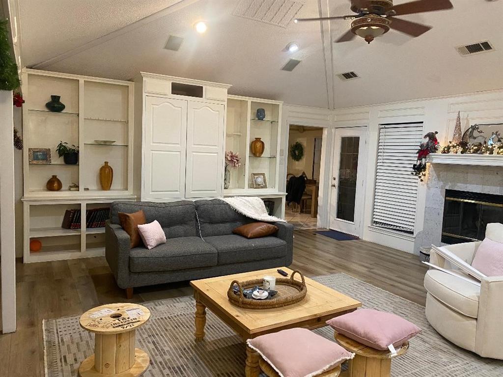 a living room with furniture and a fireplace