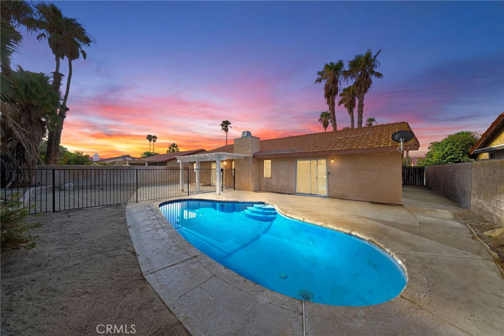 a view of a swimming pool with a yard