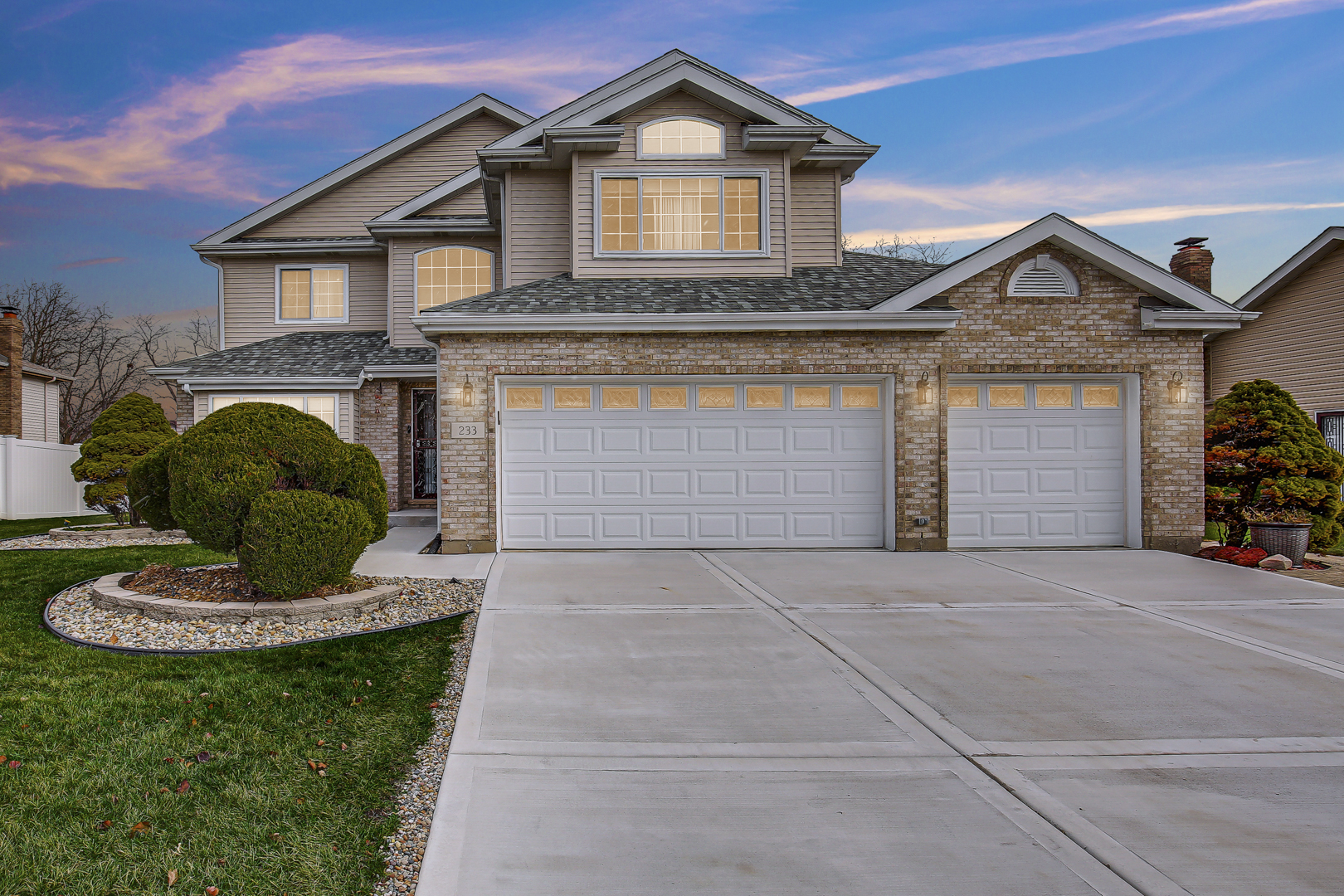 a front view of a house with a yard and garage