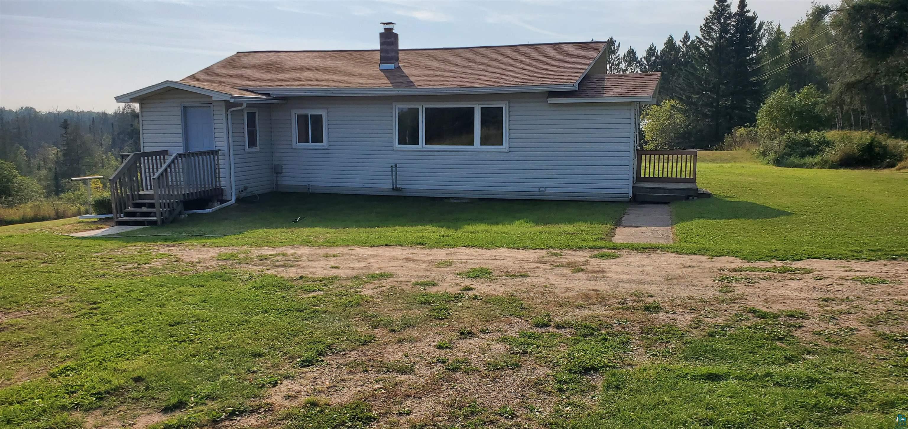 Back of property featuring a yard and a deck