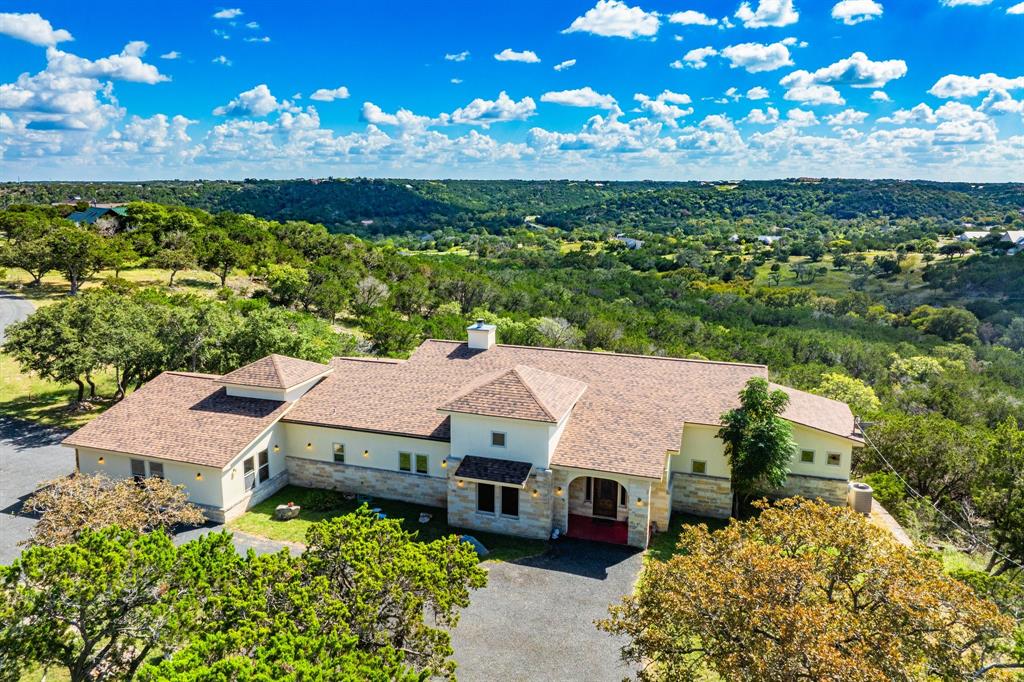 an aerial view of a house with a yard