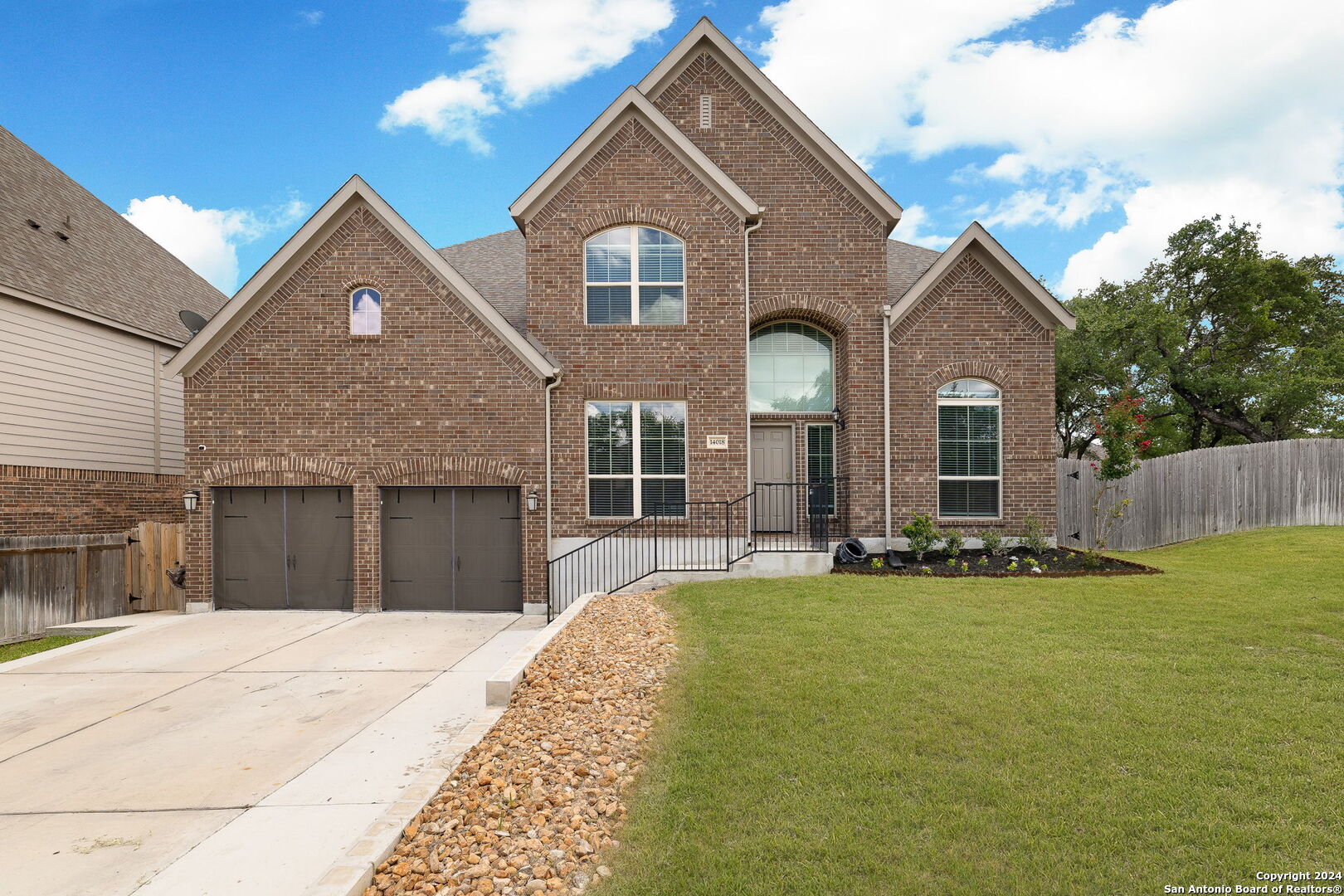 a front view of a house with a yard