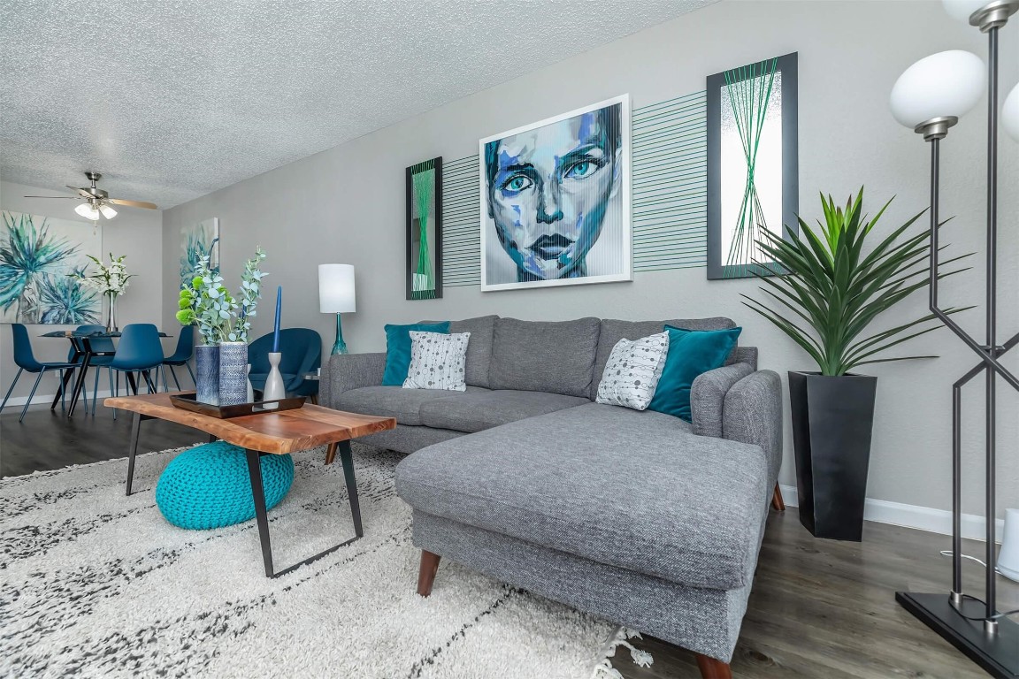 a living room with furniture and a potted plant