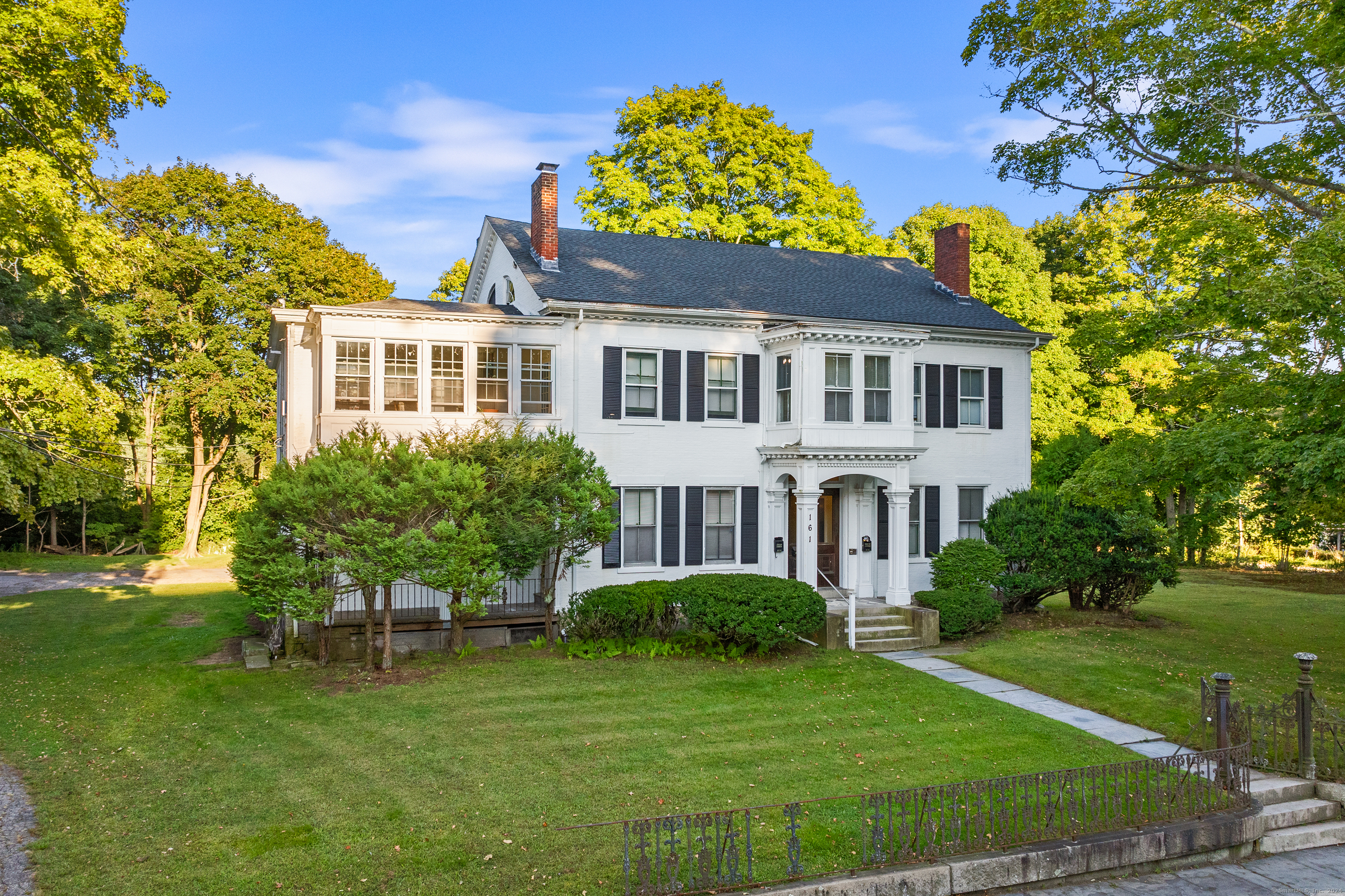 a front view of a house with a garden