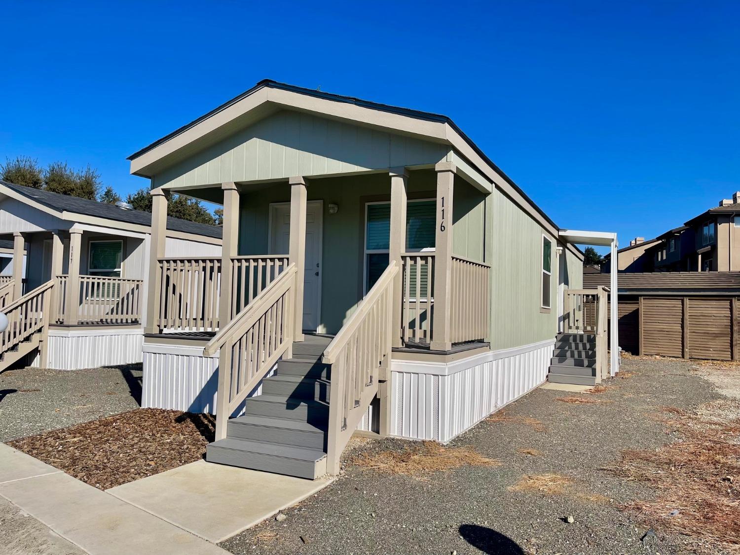 a front view of a house with wooden fence