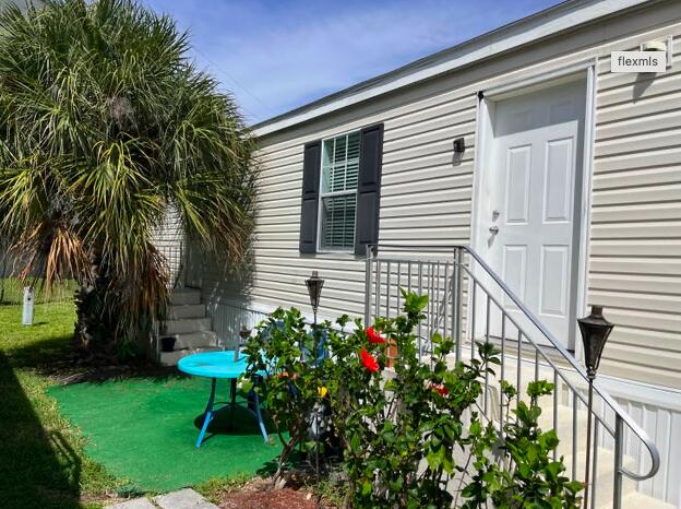 a view of a house with a yard and a garden