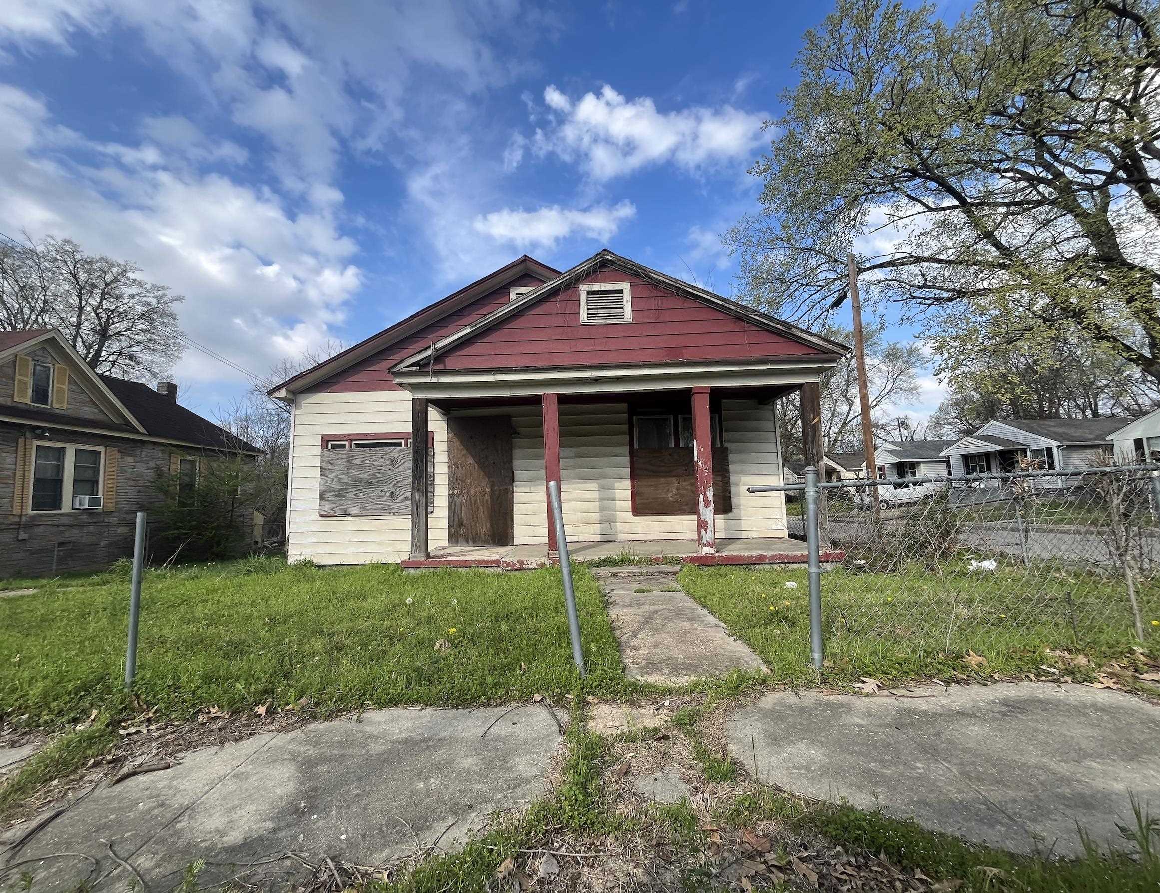 Bungalow-style house with a front yard and covered porch