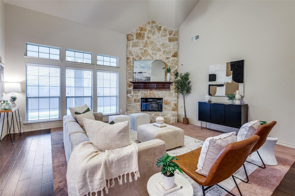 a living room with furniture a fireplace and a flat screen tv